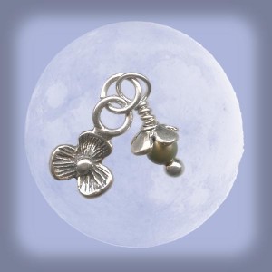  The delicate sprout charm features a Swarovski pearl, a sterling silver flower charm, a sterling silver flower bead cap, and a sterling silver ball-end head pin (available at www.rings-things.com.)