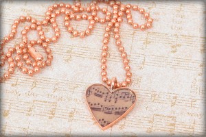 A heart-shaped bezel and Piddix image of music notes is featured in this cast resin necklace: Music Lover Necklace by Valorie Nygaard-Pouzar of www.rings-things.com