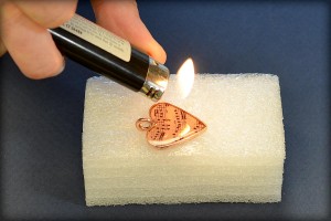 Jewelry making tutorial: how to make a clear resin image pendant from www.rings-things.com. Use a flame to rapidly raise bubbles to the surface.