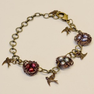Wire wrapped bird nest bracelet with freshwater pearl beads and Vintaj bird charms.