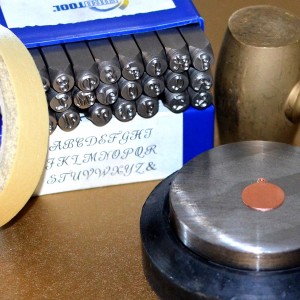 Supplies for metal stamping a charm.